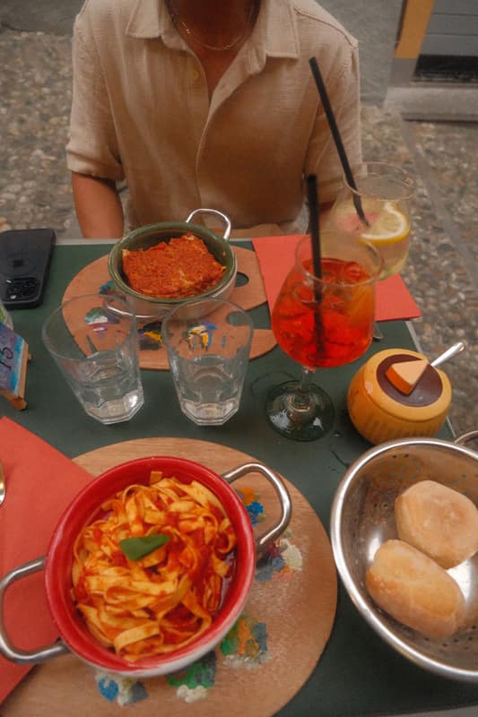 Pasta and spritzes at a lakeside lunch